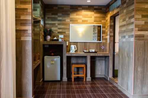 a small kitchen with a refrigerator and a counter at BaanRimNam Resort Trat in Trat