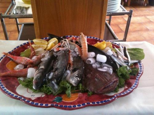 a plate of food with seafood on a table at Casa Fasano Amalfi Coast in Vietri sul Mare