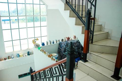 a staircase in a house with vases on the wall at White House in Wattala