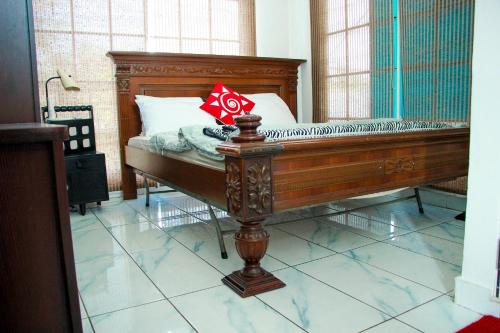 a bedroom with a wooden bed in a room at White House in Wattala