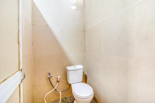 a small bathroom with a toilet in a room at KoolKost near ISI Yogyakarta (with minimum stay applies) in Yogyakarta