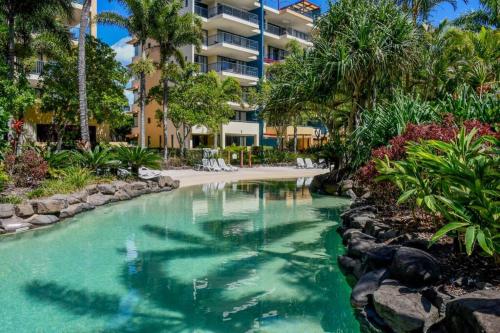 a swimming pool in the middle of a resort at Beachside 1-Bedroom Apartment -Alex and Mooloolaba in Maroochydore