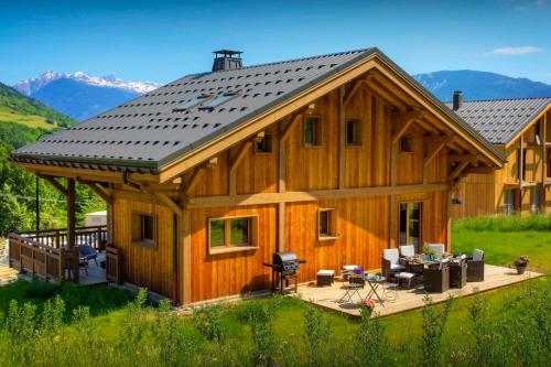 a large wooden house with a roof at Chalet Pajules - OVO Network in Le Fey