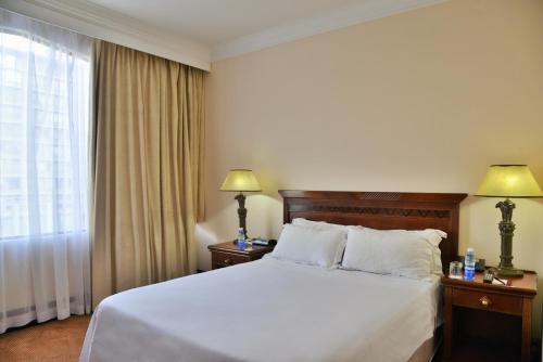 a hotel room with a bed and a window at The Capetonian - Halal in Cape Town