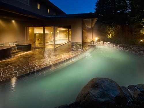 a pool of water in a backyard at night at Hakone Hisui in Hakone