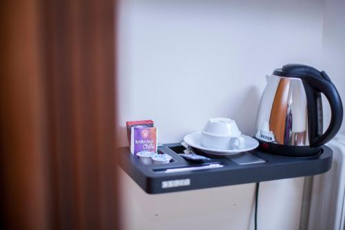 a tea kettle on a table in a room at Hotel Baden in Bonn