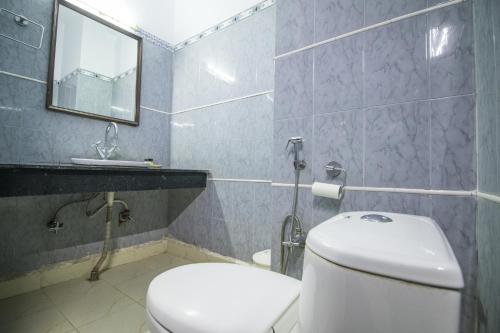 a bathroom with a toilet and a sink and a mirror at WOW STAYZ2 Hotel Jahanvi Dale in Haridwār