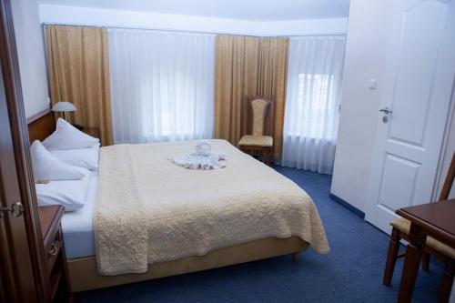 a hotel room with a bed and a chair at Hotel Baden in Bonn