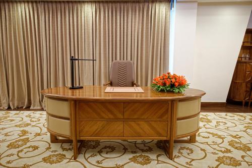 an office desk with a computer on top of it at Royal Swiss Lahore in Lahore