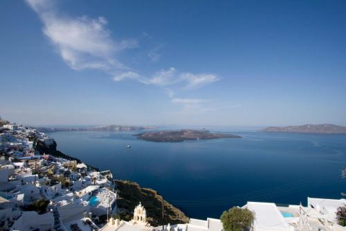 a view of a large body of water with white buildings at Villa Ilias in Firostefani