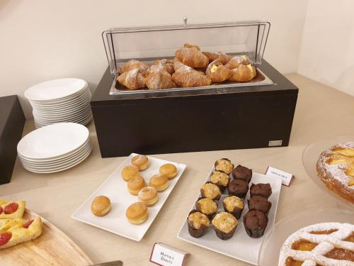 a table with various types of donuts and pastries at Il Castagneto Hotel in Melfi