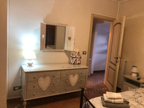 a bedroom with a dresser with a mirror at Casa in campagna a due passi dal mare in Pisa