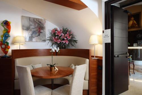 a dining room with a wooden table and chairs at Ruzzini Palace Hotel in Venice