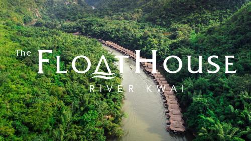 a train traveling down a river through a forest at The Float House River Kwai in Sai Yok