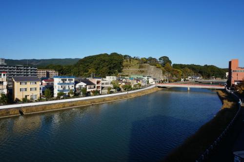 a view of a river in a city with buildings at Hotel Imari Aioibashi Bettei in Imari
