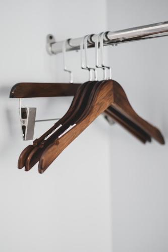 a group of wooden utensils hanging on a rack at The Wing Boutique Hotel in Chiang Mai
