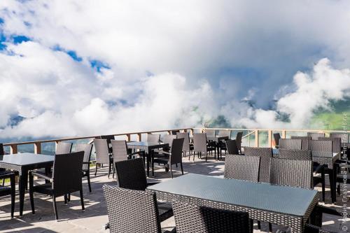 a row of tables and chairs on a balcony at Hostel near ski lift in Gudauri
