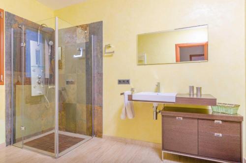 a bathroom with a shower and a sink and a mirror at Can Bou in Ses Salines