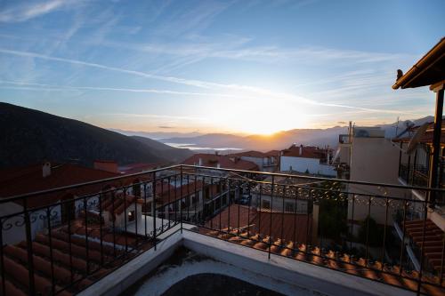 a view of the sunset from the balcony of a building at Apartment Kouros Delphi in Delfoi