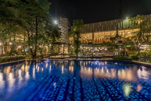 a large swimming pool in front of a building at night at Holiday Inn Cikarang Jababeka by IHG in Cikarang