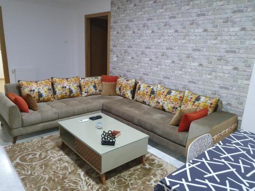 a living room with a couch and a coffee table at Appartement S+1 Jardin De Carthage in Tunis