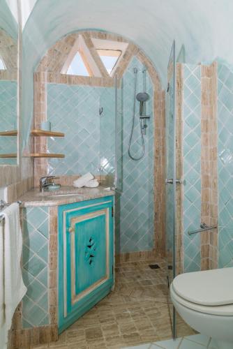 a blue bathroom with a shower and a toilet at blue sea villa in Cannigione