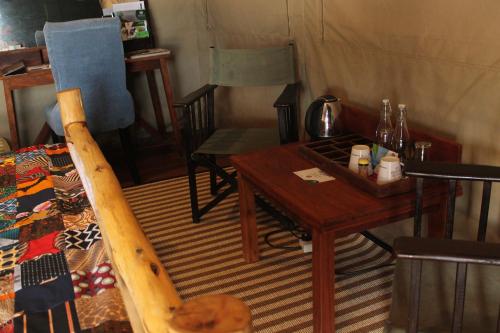 a room with a table and chairs in a tent at Wag Hill Lodge & Spa in Mwanza