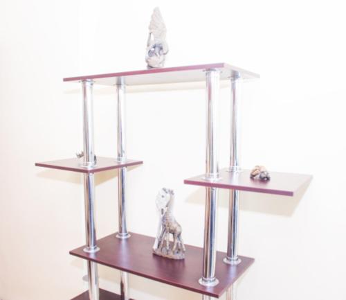 a shelf with some figurines on top of it at High Tide Beach Condo in Durban