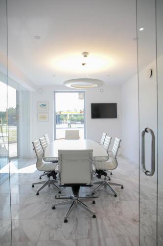 a conference room with a white table and chairs at Hotell Norrort in Vallentuna