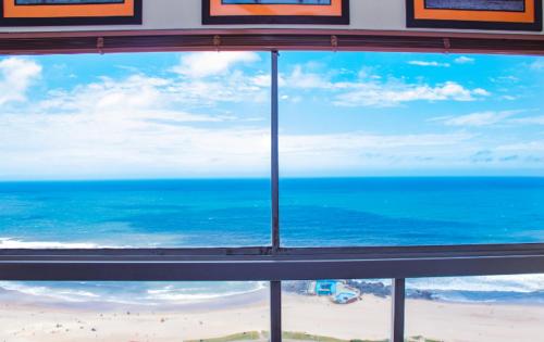 a view of the beach from a window at High Tide Beach Condo in Durban