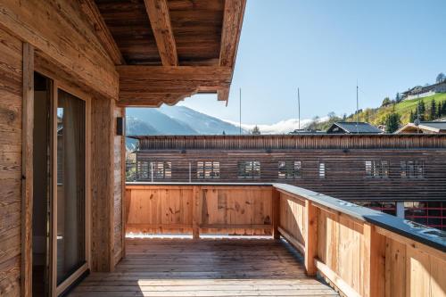 a wooden balcony with a view of a mountain at Wagstätt Residenzen Jochberg by Alpina-Holiday in Jochberg
