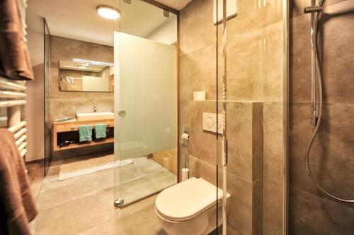 a bathroom with a toilet and a shower at Bäckerei Schranz in Sankt Leonhard im Pitztal