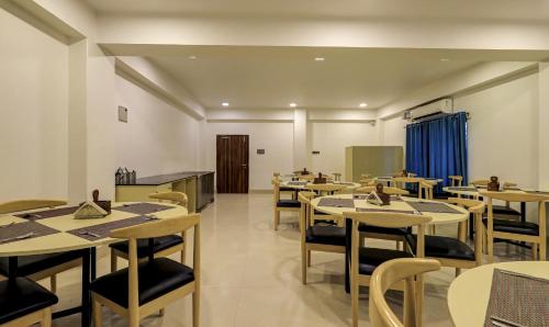 a dining room with tables and chairs at Treebo Arna Residency in Guwahati