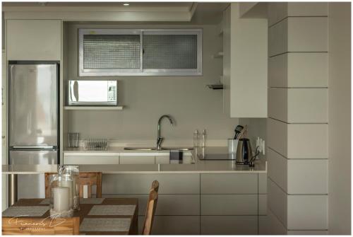 a kitchen with a sink and a counter top at View @ The Bay Apartments in Mossel Bay