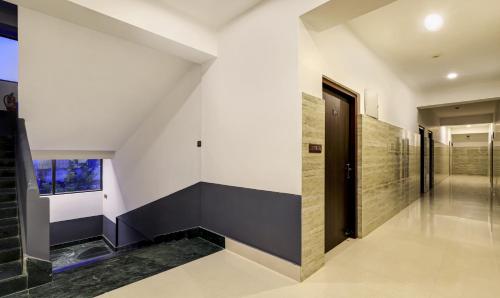 a hallway of a house with a black door at Treebo Arna Residency in Guwahati