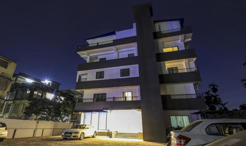 a white car parked in front of a building at Treebo Arna Residency in Guwahati