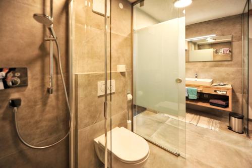a bathroom with a shower with a toilet and a sink at Bäckerei Schranz in Sankt Leonhard im Pitztal
