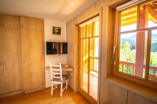 a room with a table and a window and a desk at Villa Salza in Sankt Martin am Grimming