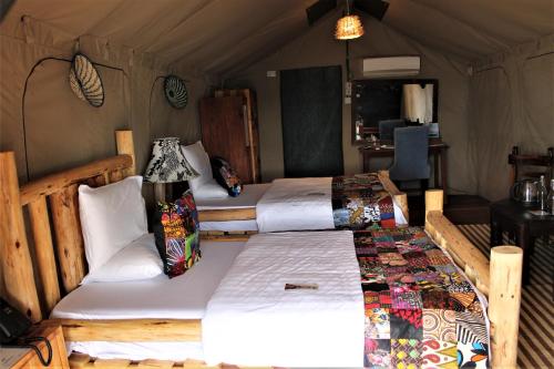 a bedroom with two beds in a tent at Wag Hill Lodge & Spa in Mwanza