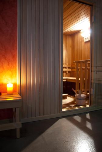 a room with a candle next to a room with a table at Villa Zina Family Resort in Custonaci