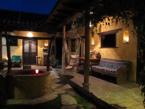 a porch with a hammock on a house at night at Posada del Abuelito (Hostel) in San Cristóbal de Las Casas