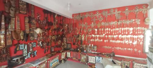 a room with a red wall with christmas decorations at Honey Guest House in Lalībela