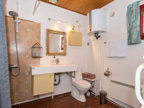 a bathroom with a sink and a toilet and a mirror at 6 person holiday home in Hemmet in Hemmet