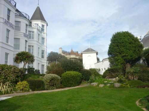 a white building with a clock tower in a yard at Royal Bath Hotel & Spa Bournemouth in Bournemouth