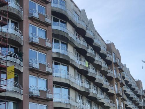 an apartment building with balconies on the side of it at Zeezicht in Ostend