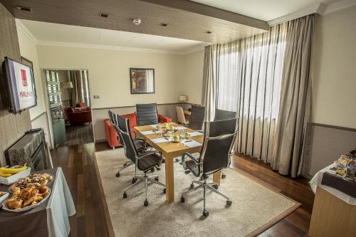 a dining room with a table and chairs at Mamaison Hotel Andrassy Budapest in Budapest