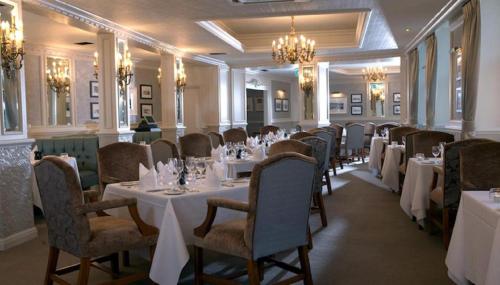 a dining room with white tables and chairs at Royal Bath Hotel & Spa Bournemouth in Bournemouth