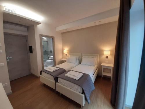 a bedroom with a large bed with two white pillows at Prestige Rooms Chiaia in Naples