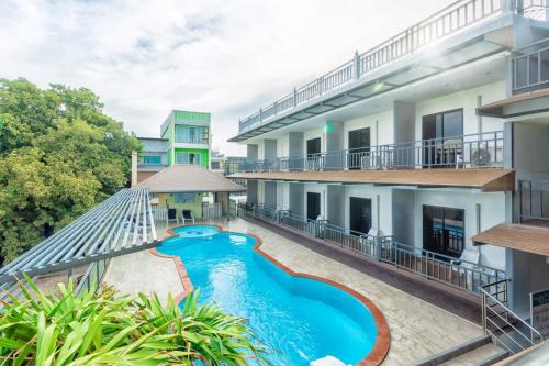 an apartment with a swimming pool in a building at CHA AM MY HOUSE Resort in Cha Am