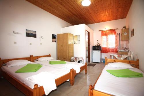 a bedroom with two beds and a kitchen at Karidies in Skopelos Town
